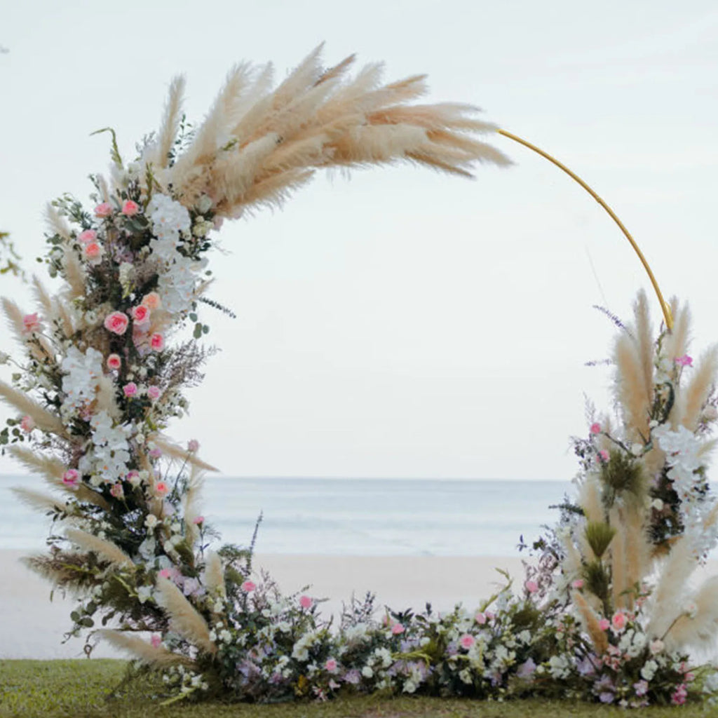 Arche circulaire de cérémonie en métal : arche avec fleurs et herbes décoratives.