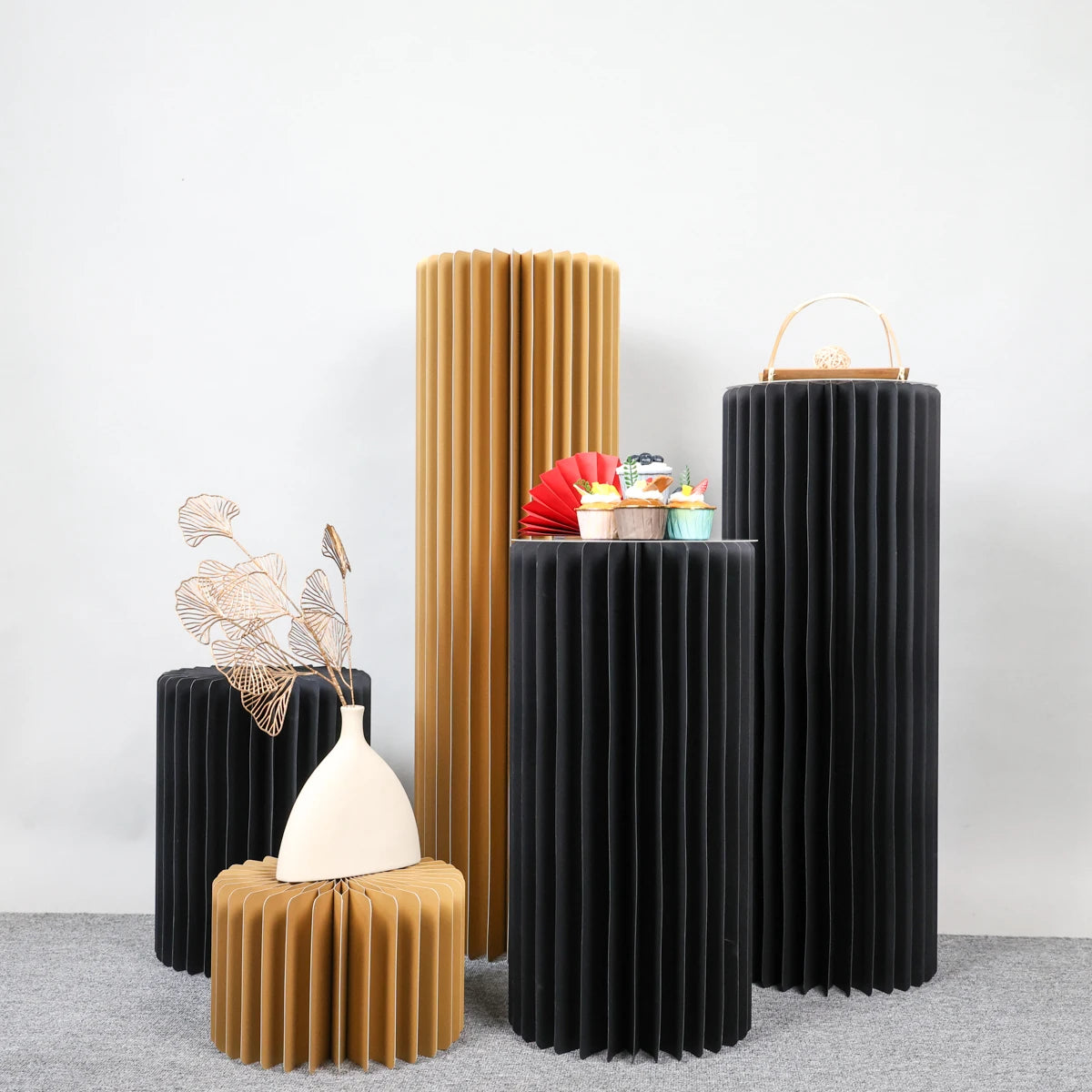 Colonnes de réception pliantes : colonnes noires et dorées avec objets décoratifs.