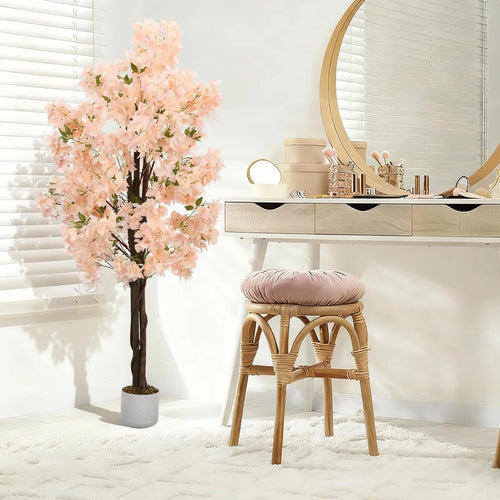Arbre artificiel de cerisier rose clair en pot, branches décoratives au salon.